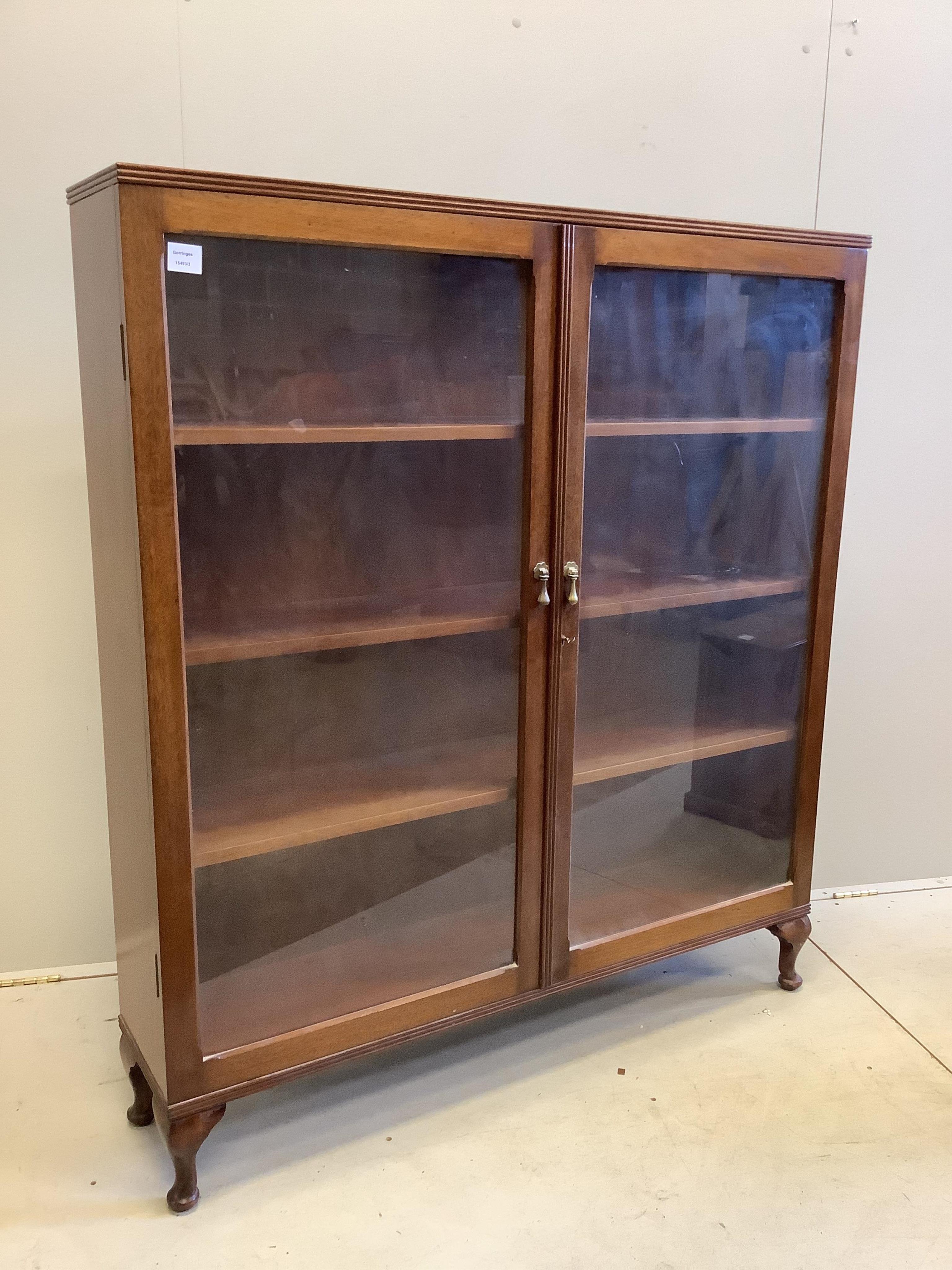 An early 20th century mahogany glazed two door bookcase, width 123cm, depth 27cm, height 139cm. Condition - good